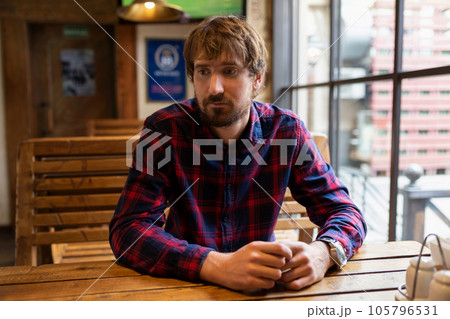 Portrait of a sad pensive man at a bar. Alcohol addiction, bad habits, unemployment, crisis 105796531