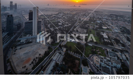 Villas in Zabeel district with skyscrapers on a background aerial night to day in Dubai, UAE Villas in Zabeel district with skyscrapers on a background aerial night to day in Dubai, UAE 105797035