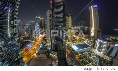 Panoramic view of the Dubai Marina and JBR area and the famous Ferris Wheel aerial night timelapse 105797173