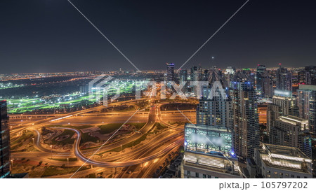 Panorama showing Dubai marina and JLT skyscrapers along Sheikh Zayed Road aerial night timelapse. 105797202
