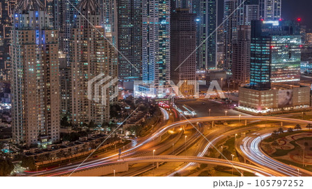 Skyscrapers of Dubai Marina near intersection on Sheikh Zayed Road with highest residential buildings day to night timelapse 105797252