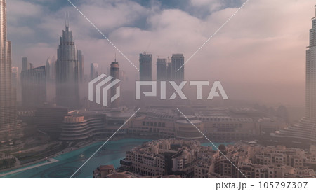 Aerial view morning fog covered Dubai International Financial Centre district timelapse 105797307