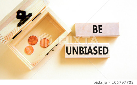 Be unbiased symbol. Concept words Be unbiased on wooden block. Beautiful white table white background. Wooden chest with coins. Business psychology be unbiased concept. Copy space. 105797705
