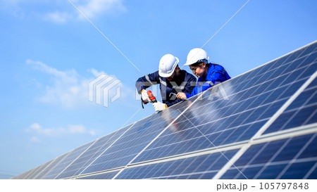 Technicians workers installing solar panels at solar cell farm Technicians workers installing solar panels at solar cell farm 105797848