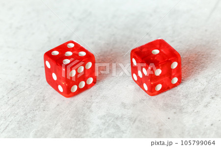 Two translucent red craps dices on white board showing Easy Six / Jimmie Hicks (number 5 and 1) 105799064