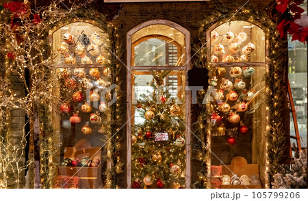 Christmas store window with festive baubles, holiday ornaments, lights, fir tree 105799206