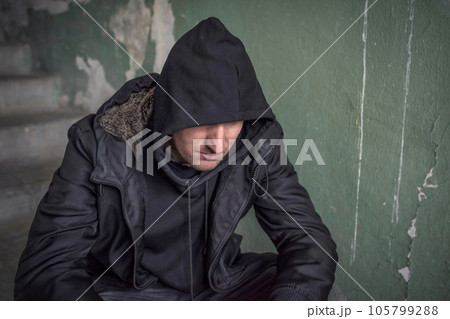 Man in the hood experiencing a drug addiction crisis. Unemployed Man in the hood experiencing a drug addiction crisis. Unemployed 105799288