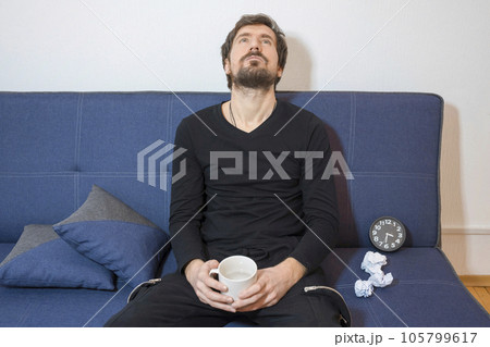 The man is depressed, sitting on the couch with a psychologist talks about his problems The man is depressed, sitting on the couch with a psychologist talks about his problems 105799617