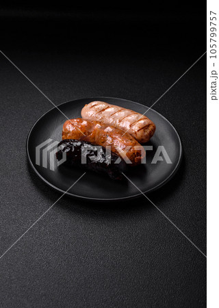Delicious juicy sausages of several varieties grilled with salt, spices and herbs 105799757