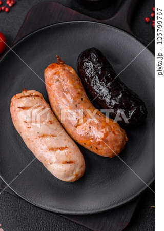 Delicious juicy sausages of several varieties grilled with salt, spices and herbs Delicious juicy sausages of several varieties grilled with salt, spices and herbs 105799767