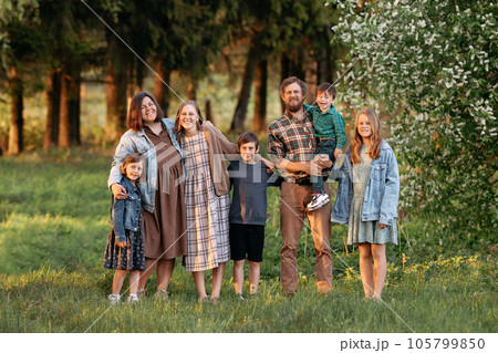 Large friendly family in the summer on the field. 105799850