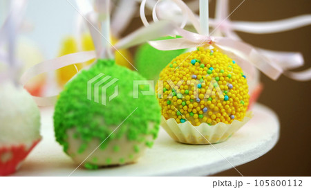 Candy bar on children's birthday. close-up, multi-colored lollipops, sweets, biscuit, cupcakes, sweet decoration for children's parties and children's anniversaries. 105800112