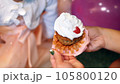 close-up, mom unwraps a festive little cupcake for her little daughter, treats her. birthday cake 105800120