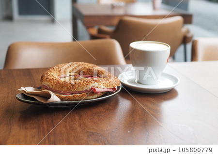 Sandwich With Smoked Chicken Salami and coffee on table Sandwich With Smoked Chicken Salami and coffee on table 105800779