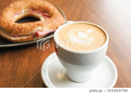 a cup of late coffee with flower shape design on top at cafe a cup of late coffee with flower shape design on top at cafe 105800786