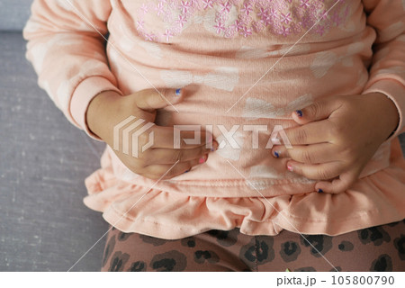 child suffering stomach pain close up. 105800790