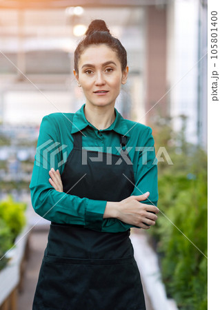 Young woman works in flower plants department in DIY store Young woman works in flower plants department in DIY store 105801400
