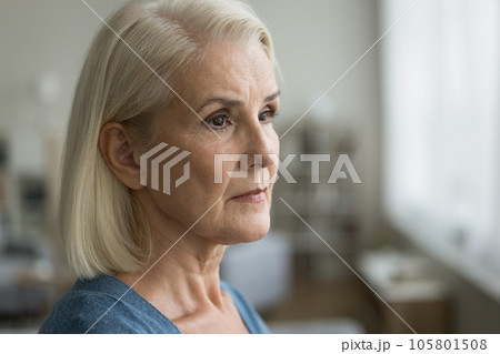 Serious pensive senior woman looking at window away 105801508