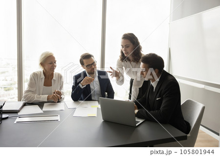 Professional colleagues working on project together, watching project content 105801944