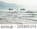Boats floating near the beach besides the mountain in the brilliant dawn 105805374