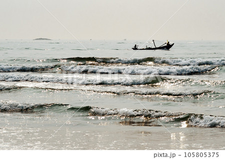 A boat floating on the sea in the brilliant dawn 105805375