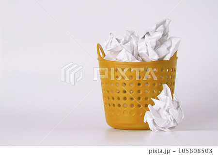 Trash can. Full basket. Crumpled paper in a basket. 105808503