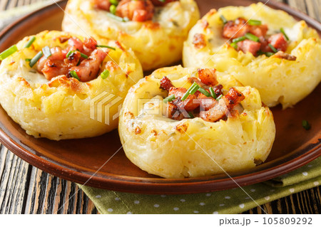 Stuffed Mashed Potato Nests Filled With Bacon And Onion close-up in a plate. Horizontal Stuffed Mashed Potato Nests Filled With Bacon And Onion close-up in a plate. Horizontal 105809292