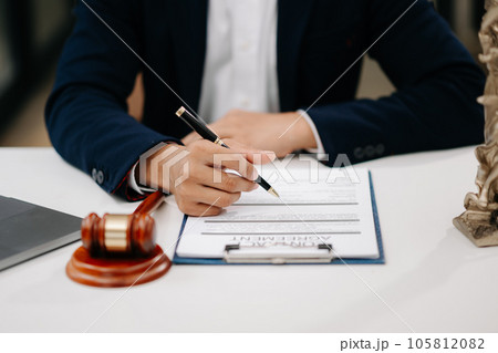 justice and law concept.Male judge in a courtroom on wooden table and Counselor or Male lawyer working in office. . 105812082
