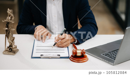justice and law concept.Male judge in a courtroom on wooden table and Counselor or Male lawyer working in office. . justice and law concept.Male judge in a courtroom on wooden table and Counselor or Male lawyer working in office. . 105812084