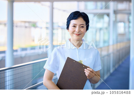 病院で働くベテラン看護師 105816488