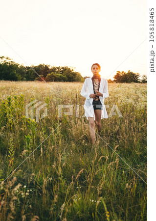 Portrait of woman in golden sunset light in outdoor meadow. Springtime and summer lifestyle. Wellbeing and zen like meditation activity in outdoor. Loving life 105818465