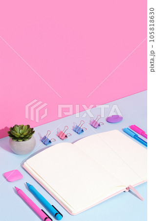 Stationary background with pink, blue and violet pens, clips on magenta and cyan backdrop. Stationary background with pink, blue and violet pens, clips on magenta and cyan backdrop. 105818630