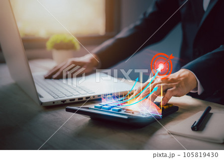 Investment growing according to the goal. income tax paid, dividend, interest rate and corporations. Businessman calculating with calculator, laptop (notebook) of return on financial research, report 105819430