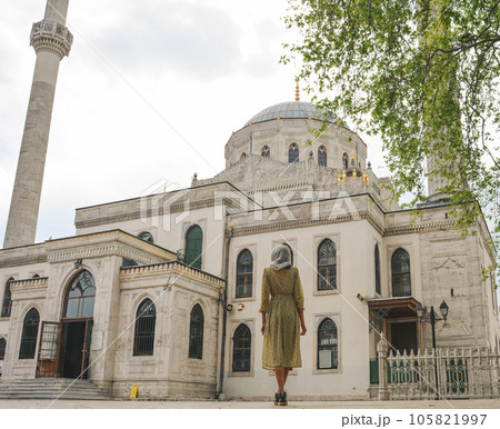 Happy attractive muslim woman near mosque in istanbul turkey posing in courtyard of mosque, religion and travel concept 105821997