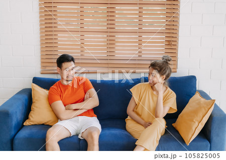Couple lover is having an argument sitting on the sofa in the house. Couple lover is having an argument sitting on the sofa in the house. 105825005