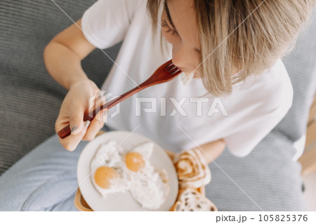 Portrait of woman eating her simple and easy breakfast. Portrait of woman eating her simple and easy breakfast. 105825376