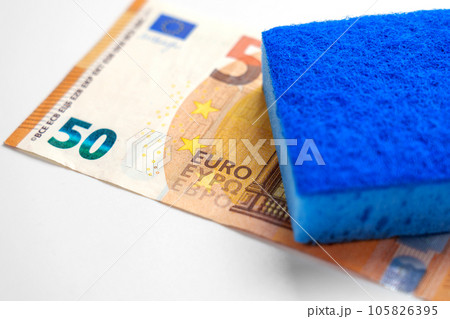 Money laundering concept. Criminal cleaning euro banknotes. Cash european currency with blue sponge 105826395