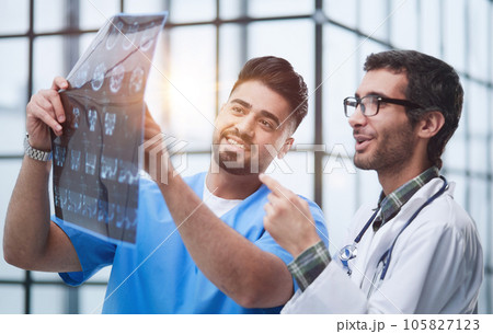 Two caucasian doctors view mri picture and discussing about it. Close up. 105827123