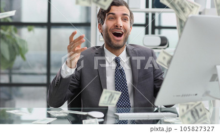 Shocking news. Surprised young man in a suit and tie looking at 105827327