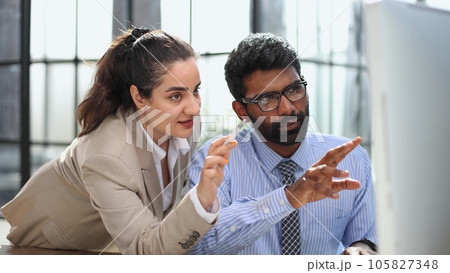 Design professionals using a laptop together in an office Design professionals using a laptop together in an office 105827348