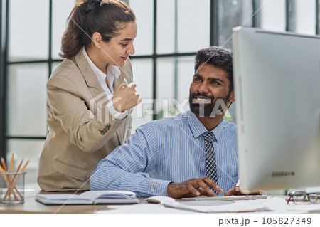 Working together on project. Two young business colleagues working on computer 105827349