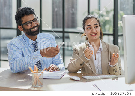 Smart business people working together with laptop while talking in the coworking place. 105827355