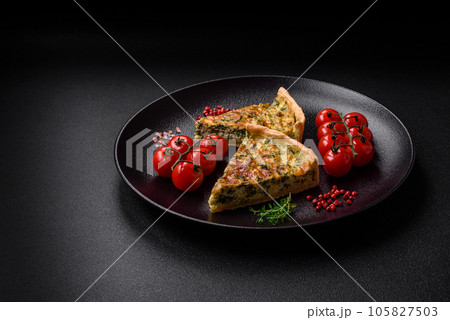 Delicious fresh quiche with broccoli, cheese, spices and herbs cut into pieces Delicious fresh quiche with broccoli, cheese, spices and herbs cut into pieces 105827503