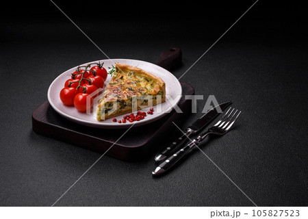 Delicious fresh quiche with broccoli, cheese, spices and herbs cut into pieces 105827523