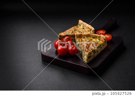 Delicious fresh quiche with broccoli, cheese, spices and herbs cut into pieces 105827526