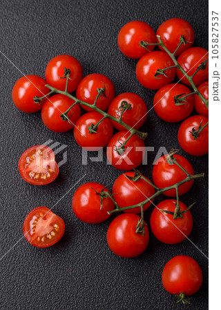 Delicious fresh cherry tomatoes on the branches as an ingredient for cooking a vegetarian dish Delicious fresh cherry tomatoes on the branches as an ingredient for cooking a vegetarian dish 105827537