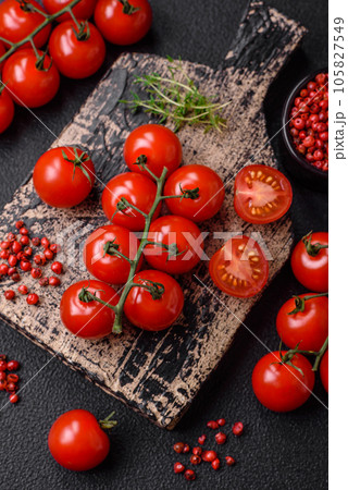 Delicious fresh cherry tomatoes on the branches as an ingredient for cooking a vegetarian dish Delicious fresh cherry tomatoes on the branches as an ingredient for cooking a vegetarian dish 105827549