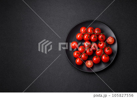 Delicious fresh cherry tomatoes on the branches as an ingredient for cooking a vegetarian dish Delicious fresh cherry tomatoes on the branches as an ingredient for cooking a vegetarian dish 105827556