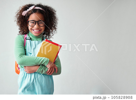 School, portrait of child student with books for knowledge, education and studying in a studio. Happy, smile and young smart girl kid with glasses for reading by a white background with mockup space. School, portrait of child student with books for knowledge, education and studying in a studio. Happy, smile and young smart girl kid with glasses for reading by a white background with mockup space. 105828908