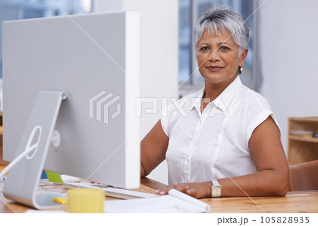 Computer, portrait and mature woman in office for online management, digital planning and working with career mindset. Confident indian person, professional worker or business employee on desktop pc Computer, portrait and mature woman in office for online management, digital planning and working with career mindset. Confident indian person, professional worker or business employee on desktop pc 105828935